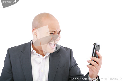 Image of Angry business man screaming on cell mobile phone, portrait of y