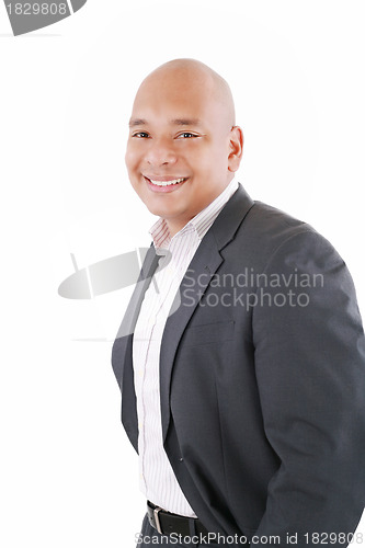 Image of Happy businessman standing with hands in pocket, looking at came
