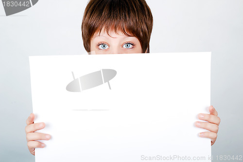 Image of young girl hiding a banner