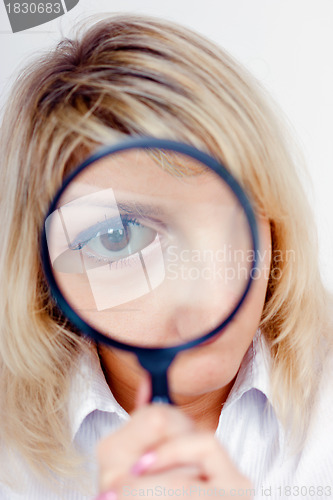 Image of woman looking through a magnifying glass