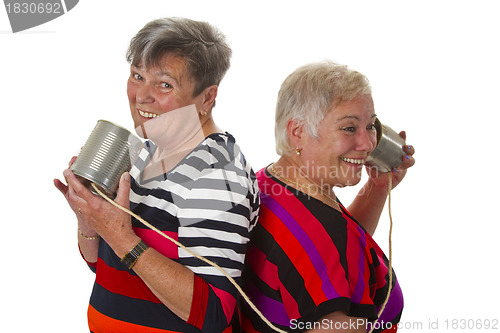 Image of Female senior talking with can telephone