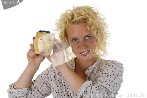 Image of Beautiful young woman with piggy bank