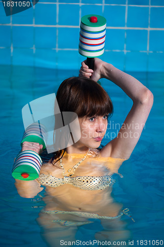 Image of Pretty girl doing aqua aerobic exercise