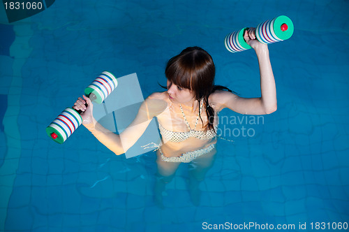 Image of Pretty girl doing aqua aerobic exercise