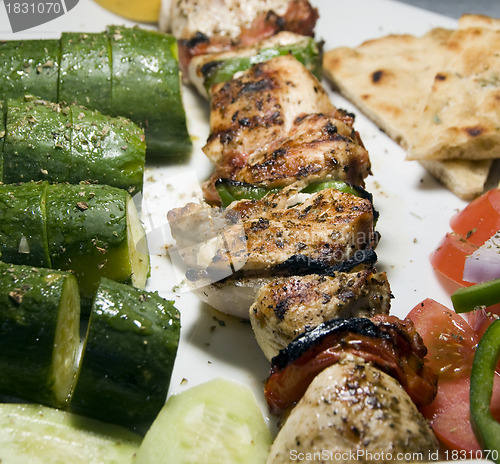 Image of chicken shish kabob with zucchini  salad Greek style as photogra