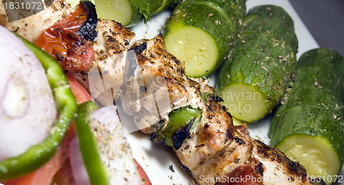 Image of chicken shish kabob with zucchini  salad Greek style as photogra