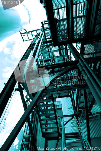 Image of industrial ladders, cables, pipelines in blue tones