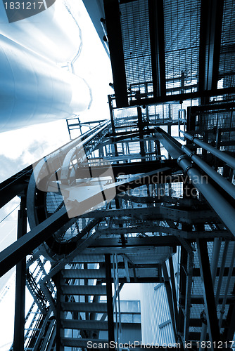 Image of industrial ladders, cables, pipelines in blue tones