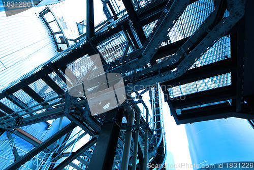 Image of industrial ladders, cables, pipelines in blue tones