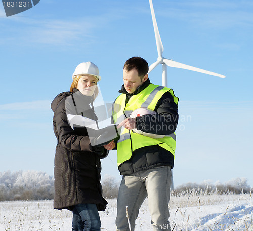 Image of team of  engineers or architects with white safety hat and wind 