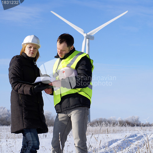 Image of team of  engineers or architects with white safety hat and wind 