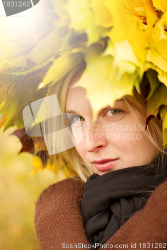 Image of Woman with autumn wreath outdoors
