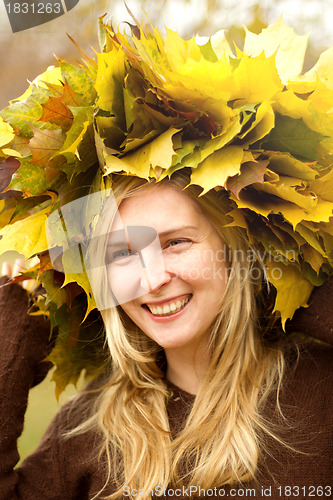 Image of Woman with autumn wreath outdoors