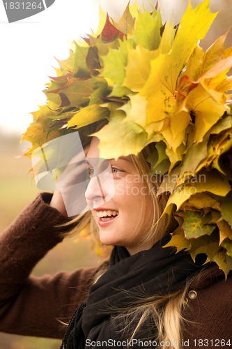 Image of Woman with autumn wreath outdoors