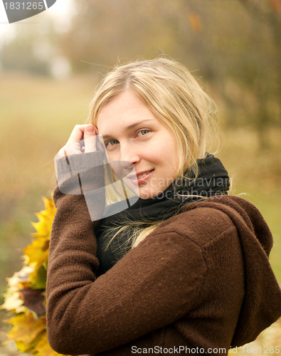 Image of Woman with autumn wreath outdoors
