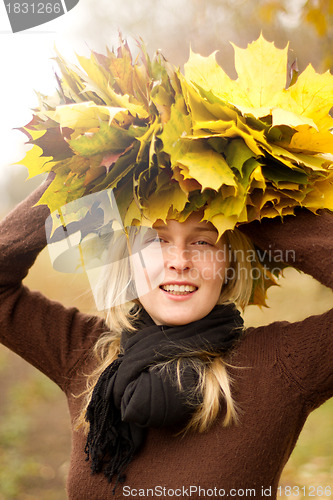 Image of Woman with autumn wreath outdoors