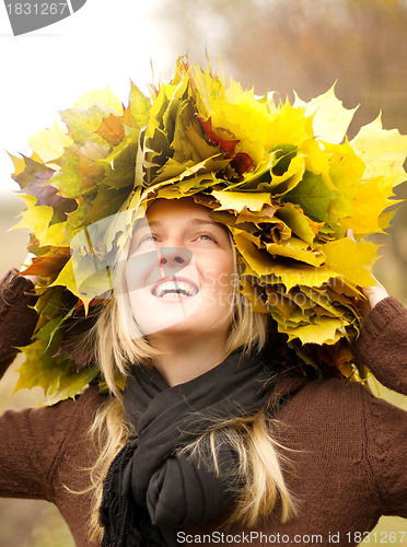 Image of Woman with autumn wreath outdoors