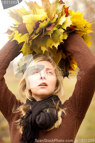 Image of Woman with autumn wreath outdoors