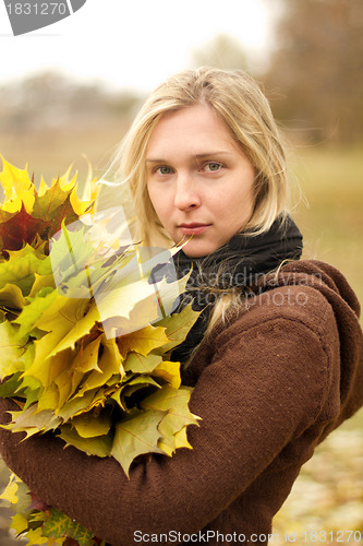 Image of Woman with autumn wreath outdoors