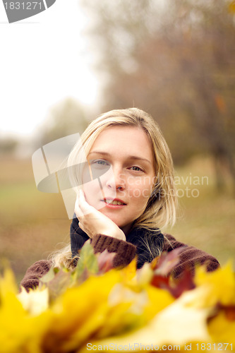 Image of Woman with autumn wreath outdoors