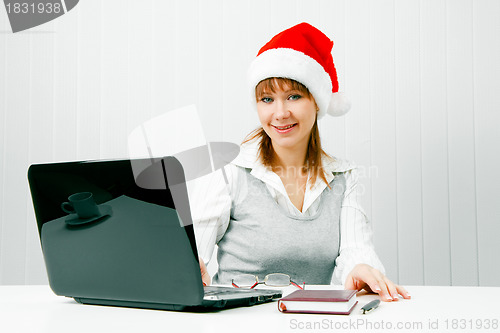 Image of girl in a Christmas hat with a laptop