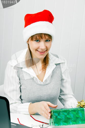 Image of Attractive girl with a Christmas present