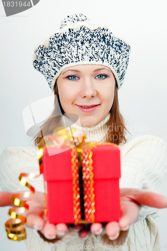 Image of Attractive girl gives a wrapped gift