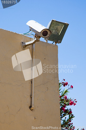 Image of Video camera of system of supervision on a building wall 