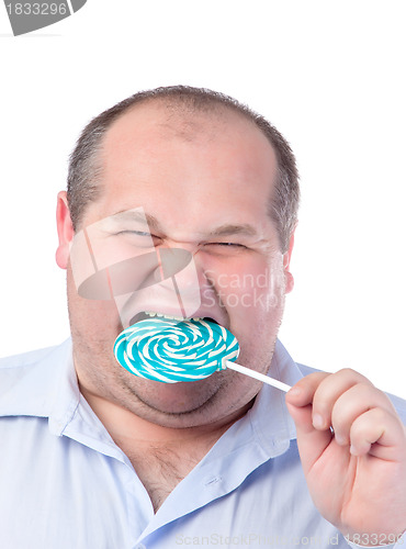 Image of Fat Man in a Blue Shirt, Eating a Lollipop