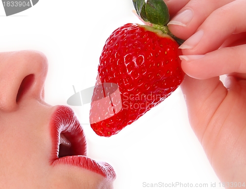 Image of Woman with strawberry on her red lips