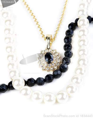 Image of beads and chain with a pendant