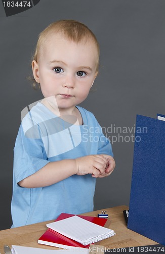 Image of young child at small desk