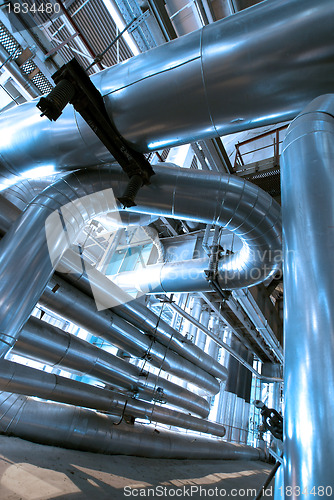 Image of industrial ladders, cables, pipelines in blue tones