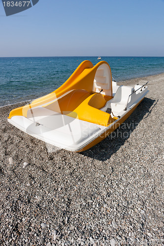 Image of Yellow catamaran on a beach