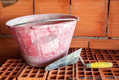 Image of Trowel, bucket and bricks