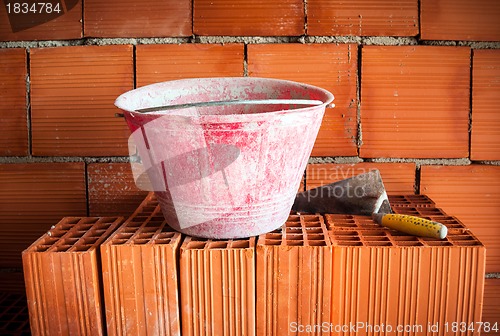 Image of Trowel, bucket and bricks