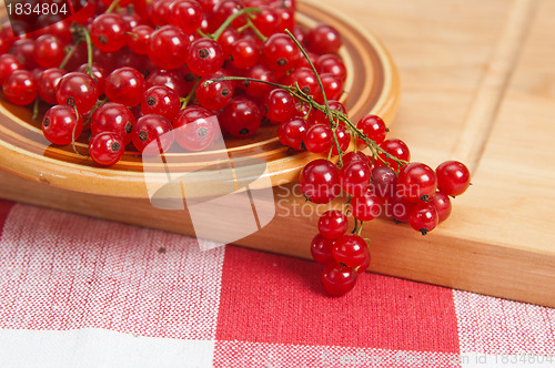 Image of Berries of a red currant in a plate on a table