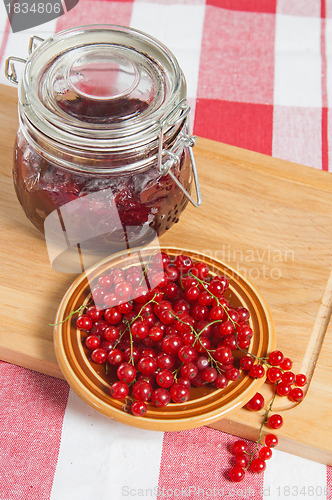 Image of Jam with berries of a red currant on a table.