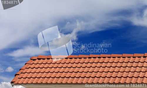 Image of Roof tiles and blue sky with clouds