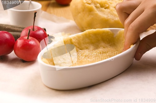 Image of Detail of child hands making apple pie