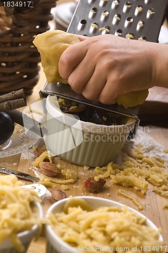 Image of Detail of child hands making plum tart