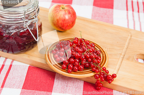 Image of Jam with berries of a red currant on a table.