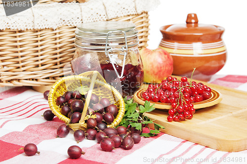 Image of Jam with berries of red currant and gooseberry on the table