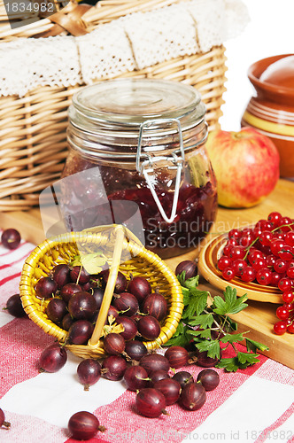 Image of Jam with berries of red currant and gooseberry on the table