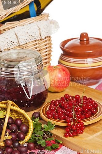 Image of Jam with berries of red currant and gooseberry on the table