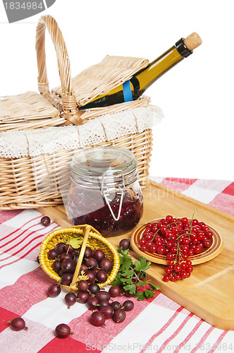 Image of Jam with berries of red currant and gooseberry on the table