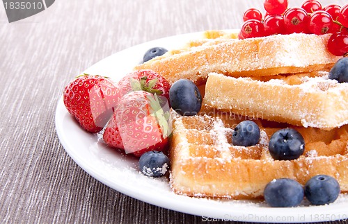 Image of sweet fresh tasty waffles with mixed fruits isolated