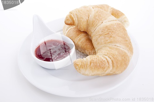 Image of deliscios fresh croissant with strawberry jam isolated