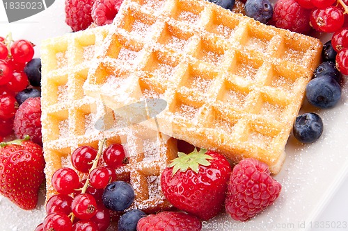 Image of sweet fresh tasty waffles with mixed fruits isolated