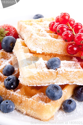 Image of sweet fresh tasty waffles with mixed fruits isolated